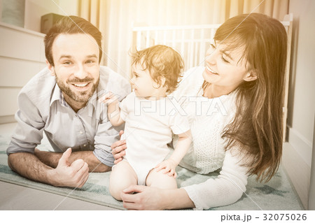 Happy family playing with a baby 32075026