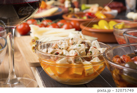 Spanish tapas starters on wooden table Spanish tapas starters on wooden table 32075749