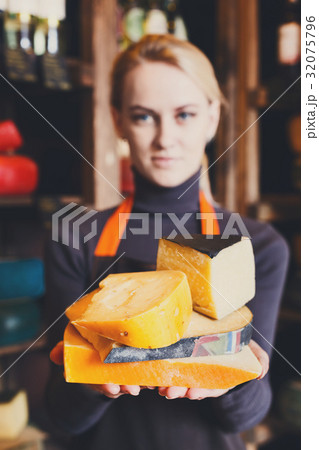Various italian hard cheese in shop assistant 32075796