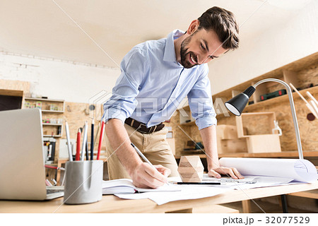 Happy lumber craftsman creating rough copies of Happy lumber craftsman creating rough copies of 32077529