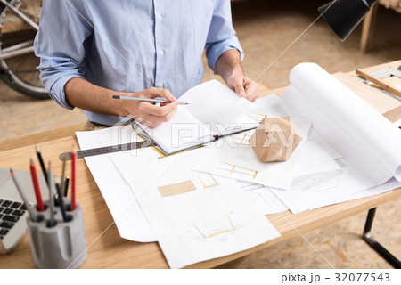Lumber craftsman drawing drafts of manufacture at 32077543
