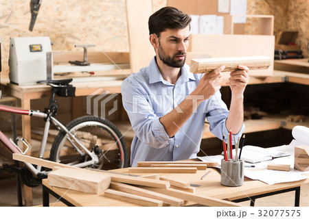 Concentrated lumber craftsman working with raw 32077575