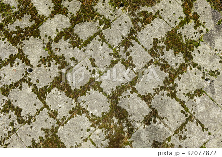 Old stone wall covered with moss Old stone wall covered with moss 32077872