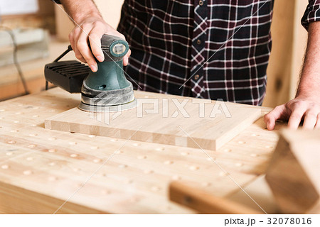 Young carpenter is working in his workshop Young carpenter is working in his workshop 32078016