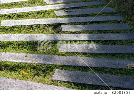 cement pathway on grass in garden 32081352