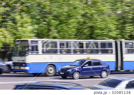 Bus rides on city road with ghost effect 32085138