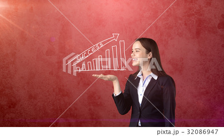 Woman holding white painted growing chart with 32086947