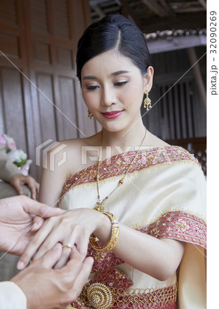 A photo of a bride receiving a wedding ring. 32090269