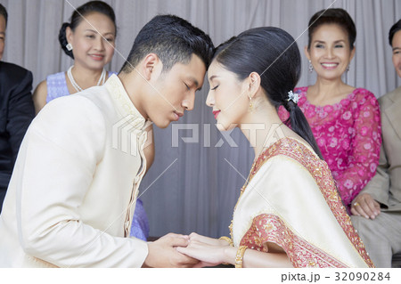 the couple are closing their eyes and holding hand each other the couple are closing their eyes and holding hand each other 32090284