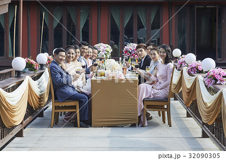 people are holding a glass of wine and toasting in a party people are holding a glass of wine and toasting in a party 32090305