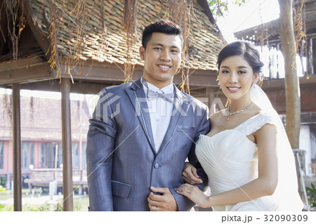 portrait of a couple is smiling and looking at something together portrait of a couple is smiling and looking at something together 32090309