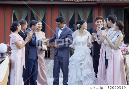 Bride and groom is blessed by their guests in wedding reception Bride and groom is blessed by their guests in wedding reception 32090319