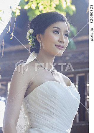 a photo of young bride smiling and looking away a photo of young bride smiling and looking away 32090325