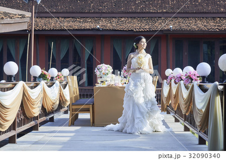 a bride is standing at wedding reception and looking away 32090340