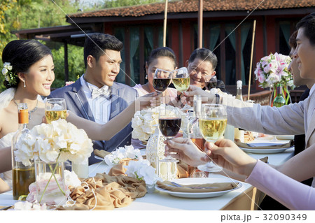 Just married couple is drinking with guests at wedding reception 32090349
