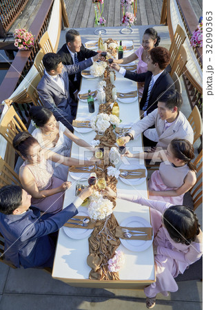 Bride and groom are clinking wine to every guest 32090363