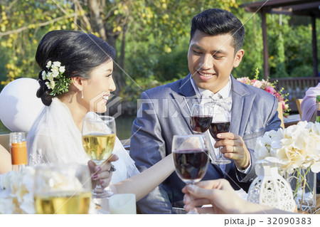 Groom and his bride are toasting together Groom and his bride are toasting together 32090383