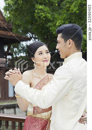 bride and groom are dancing outdoors at wedding reception 32090405