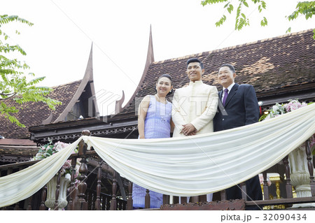 A groom's family is taking a photo in his wedding. A groom's family is taking a photo in his wedding. 32090434