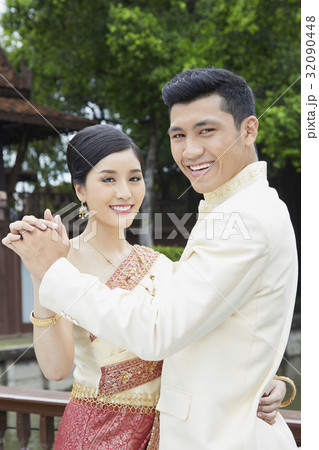 A couple is looking at someone and smiling when dancing. A couple is looking at someone and smiling when dancing. 32090448