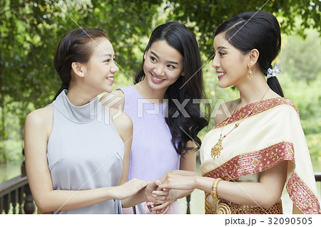 The bride is taking hands and smiling with her friends The bride is taking hands and smiling with her friends 32090505