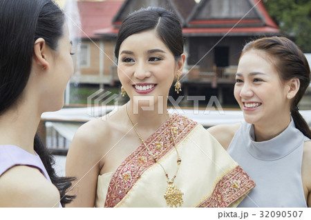 Three girls are looking and smiling together Three girls are looking and smiling together 32090507