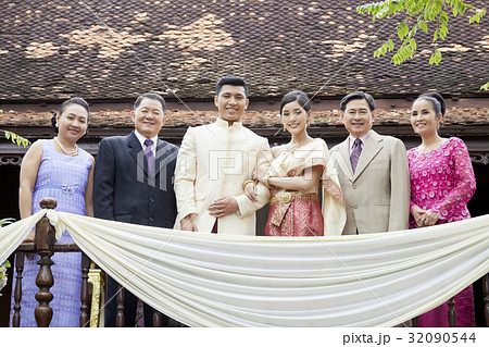 A married couple and their relatives are posing on the balcony. A married couple and their relatives are posing on the balcony. 32090544