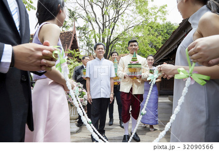 the groom is carrying traditional gifts to the bride's family. 32090566