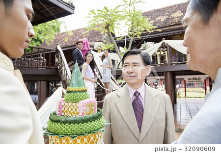 a photo of people looking at a man who is looking at something. a photo of people looking at a man who is looking at something. 32090609