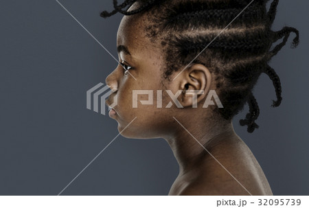 African little girl bare chest studio portrait in side view 32095739