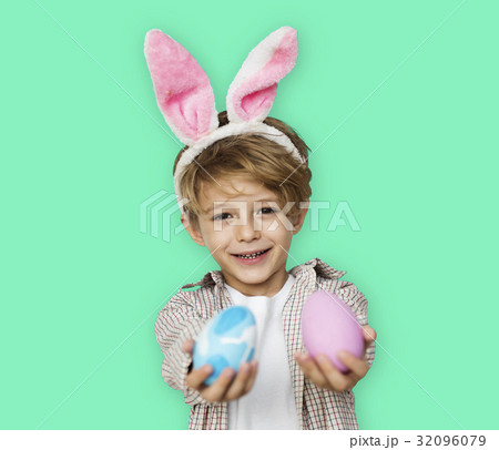 A boy with bunny hairband and easter eggs A boy with bunny hairband and easter eggs 32096079