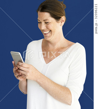 Caucasian Woman is Smiling with Smartphone Caucasian Woman is Smiling with Smartphone 32096221