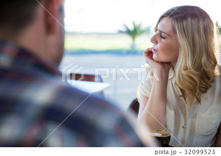 Woman sitting in coffee shop Woman sitting in coffee shop 32099523