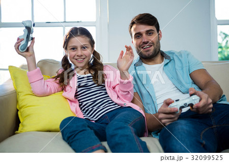 Father and daughter playing video game Father and daughter playing video game 32099525