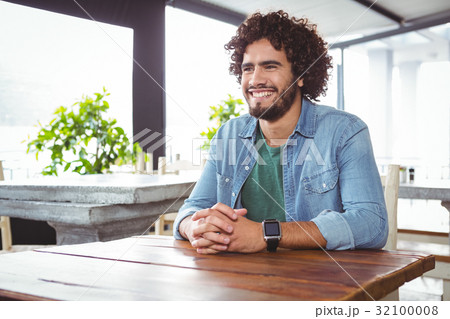 Man sitting and smiling Man sitting and smiling 32100008