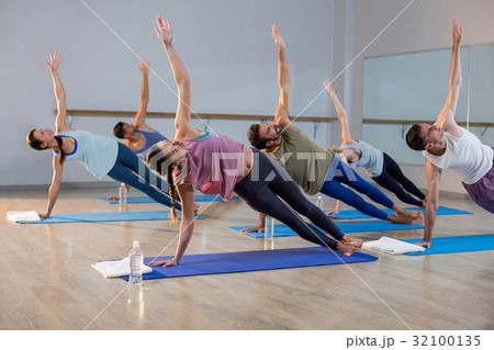 Group of people performing yoga Group of people performing yoga 32100135