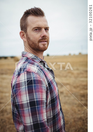 Portrait of farmer standing in the field Portrait of farmer standing in the field 32100261