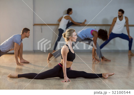 Woman performing stretching exercise Woman performing stretching exercise 32100544