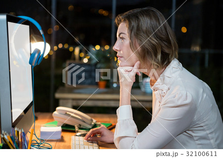 Businesswoman working on computer at her desk 32100611