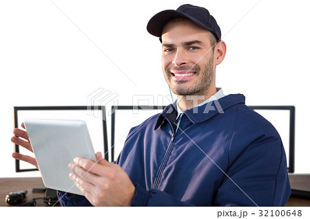 Happy security officer using digital tablet at desk 32100648