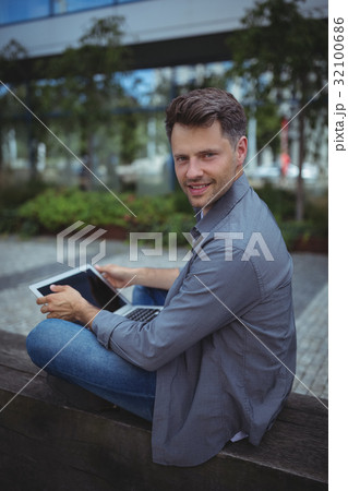 Portrait of handsome business executive using laptop Portrait of handsome business executive using laptop 32100686