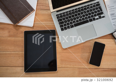 Laptop, digital tablet, mobile phone and organizer on desk Laptop, digital tablet, mobile phone and organizer on desk 32100692