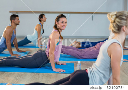 Group of people performing yoga Group of people performing yoga 32100784
