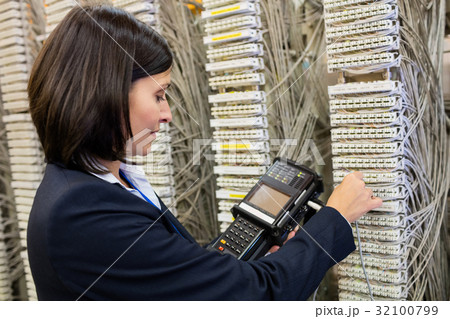 Technician using digital cable analyzer Technician using digital cable analyzer 32100799