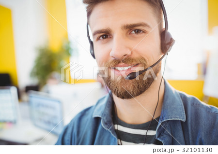 Portrait of confident executive wearing headphones at creative office 32101130