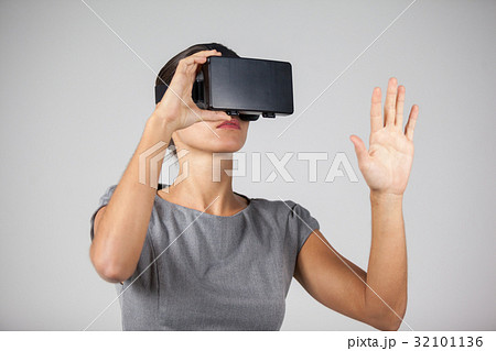 Woman using virtual reality headset Woman using virtual reality headset 32101136