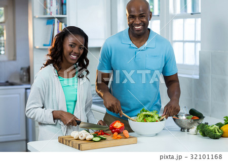 Portrait of couple preparing food Portrait of couple preparing food 32101168