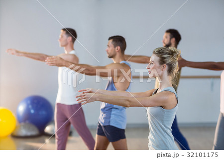 Group of people performing yoga 32101175