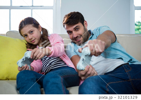 Father and daughter playing video game 32101329