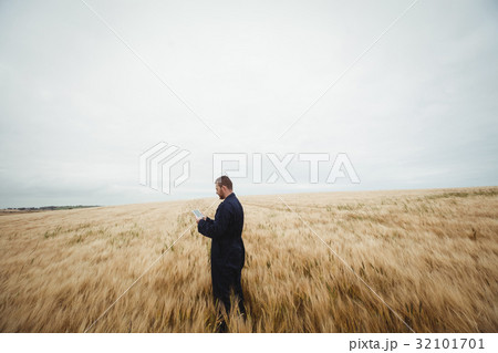 Farmer using digital tablet in the field Farmer using digital tablet in the field 32101701